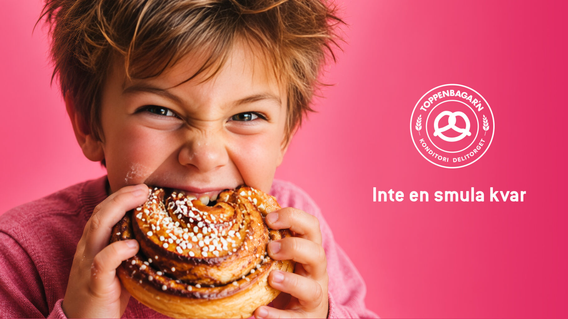 a boy eating a cinnamon roll